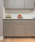 Modern kitchen with grey cabinets featuring 30 Pack Brushed Nickel Square Cabinet Pulls 5 Inch Overall Length With 3 Inch Center Mount Half Inch Width.