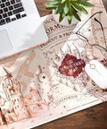 Harry Potter Marauder's Map Desk Mat XXL Gaming Desk Pad on wooden desk with laptop and plant; waterproof neoprene surface, non slip backing.