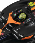 Close-up of McLaren MCL38 1:43 Scale 2024 Die-Cast Formula Car cockpit with helmet, showing realistic decals and driver details.