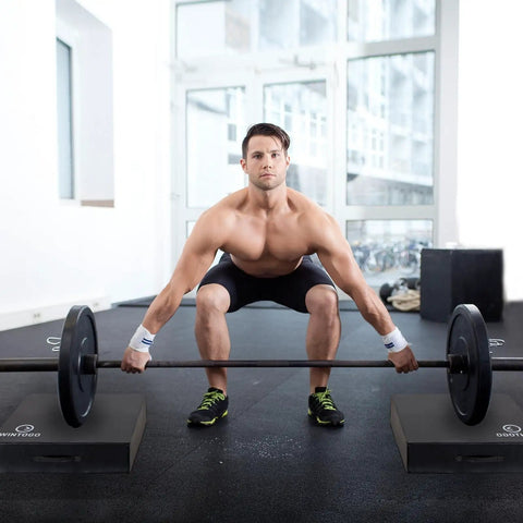 Man performing barbell deadlift on Deadlift Drop Pads Pair For Quiet Home Gym Lifts, Noise Reducing Heavy Duty Weightlifting Mats.