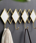 Dang Solid Wall Mount Coat Hook Featuring Heavy Duty Wrought Iron Craft with a rustic design for holding coats and bags.