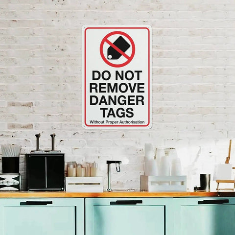Industrial Grade Aluminum Safety Sign 8x12 Inch No Tampering Lockout Caution Plaque on brick wall indoors.