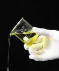 Hand holding a beaker from Twenty Pack 100 Milliliters Glass Beakers Set, Heavy Duty Borosilicate Lab Beakers With Printed Measurements