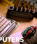 Close-up of a Cordless Electric Screwdriver With Quick Change Chuck And Six Bits For Quick DIY Screw Fastening In The Home Or Workshop Handles Tough Repetitive Fastening Jobs Like A Pro working on an electronic circuit board.