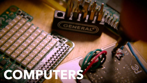 Close-up of a Cordless Electric Screwdriver With Quick Change Chuck And Six Bits For Quick DIY Screw Fastening In The Home Or Workshop Handles Tough Repetitive Fastening Jobs Like A Pro working on an electronic circuit board.