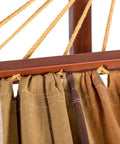 Close-up of Two Person Cotton Fabric Hammock With Spreader Bars And 10.5 Ft Wood Arc Stand showing brown and khaki fabric.