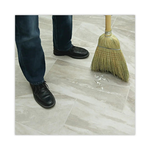 Reliable Workhorse Warehouse Brooms Crafted With Heavy Duty Corn Fiber Bristles For Ridiculously Fast Dust Removal Along With A Balanced Fifty Six Inch Overall Length To Keep Any Commercial Floor Looking Crisp Without Breaking A Sweat Daily. A person sweeping broken pieces on a commercial floor.