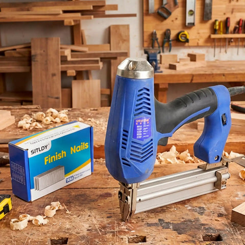 Premium 2 Inch 304 Stainless Steel Finish Nails 1000 Pack 16 Gauge Badass Brad Nails with a pneumatic nailer on a workbench.