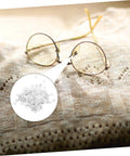 Close-up of gold rimless glasses on fabric with inset 200 Pcs Eyewear Rimless Glasses Washers Cushions Gaskets For Quick Repairs.