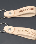 Top Shelf Natural Veggie Tan Leather Keychain Blanks 10 Pack with engraved designs, thick straps for custom crafting.