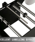 Close-up of VFLDKRQAWYS MT-30 Semi-Automatic Bottle Labeling Machine For Plastic Glass Metal Round Cylinders showing sturdy stainless steel rollers.