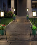 Dope Solar Outdoor Floor Lamp With Plant Stand 2 Pack Waterproof Metal Garden Lights illuminating a walkway