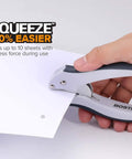 Hand using Pack Of 5 EZ Squeeze One-Hole Punch Set With 10 Sheet Capacity, lightweight gray blue workhorse on paper