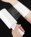 Heavy Duty Clear Stretch Wrap Film With Built In Handle, Smooth Roll Polyethylene Pallet Wrap, 4.7 X 492 Feet used on a hand.