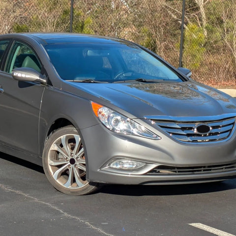 Front view of a gray Hyundai Sonata parked outside, showcasing the design of the 2011-2013 model in a sunny setting.
