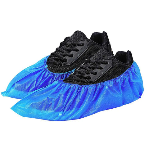 Blue Non Slip Waterproof Disposable Shoe Covers Thick Stretchable Boot Covers on black shoes, protecting floors and carpets.