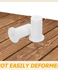 Get These Cool Silicone Wall Hole Plugs To Block Dirt And Water! Perfect 4 Pack For 25mm Cables Makes Home Improvement Super Easy With Gray And White Look. White silicone wall hole plugs on wood surface, 25mm cable grommets