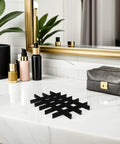Adjustable Jewelry Organizer With Ultra Soft Sponge Lining And Removable Grid Dividers Keeps Your Bling Stash Hella Organized Compact Black Drawer Insert on a marble surface.