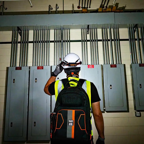 Worker wearing Rechargeable Wide Beam Headlamp With Strap And 575 Lumens Five Lighting Modes All Day Runtime Direct Focus And Hard Hat Compatibility