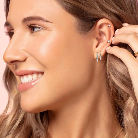 Surgical Steel Earrings Set For Multiple Piercings Nine Pairs Featuring Hoops CZ Studs And Ball Studs For Women Hypoallergenic 20G Dope Everyday Wear Must Have Jewelry With Three Styles And Sizes, model wearing hoop and ball studs