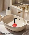 Heavy Duty Mini Sink Plunger With Reinforced Rubber Cup creates incredible suction in white bathroom sink.