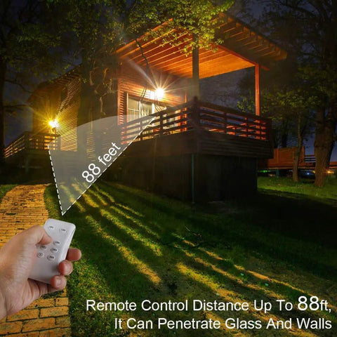 JUDYSSY Outdoor Solar Flood Lights with Remote Control illuminating a house from 88 feet away, showcasing remote features and design.
