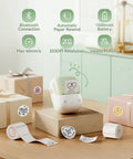 No Sweat Portable Label Maker With Bluetooth And One Touch Offline Printing For Sweet Home Office Organization Ready To Roll Including Tape In Classic Green White Finish on a wooden desk with labels and gifts.