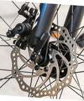 Close-up of complete front mechanical disc brake kit with heavy duty rotor and precision caliper for mountain bikes.