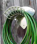 Heavy Duty 13 Inch Cast Aluminum Hose Rack For Outdoor Walls, Curved Wall Mount Hose Holder with green hose attached.