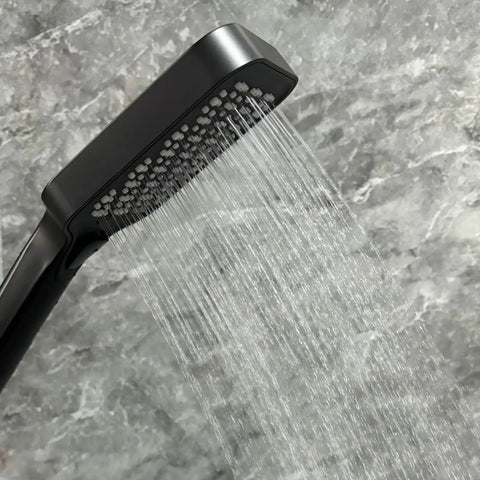 Upgrade Your Bathroom with This Matte Black Handheld Shower System - Adjustable Slide Bar & Hose High-Pressure Spray Easy-Clean Silicone Nozzles with water streaming.