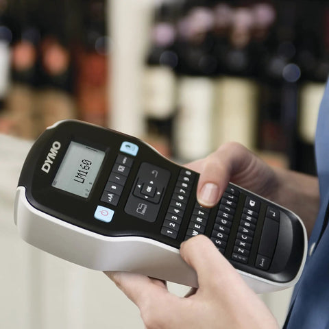 Hand holding Badass Portable Label Maker Featuring Authentic Qwerty Keyboard And Rapid Response Touch Keys in black.