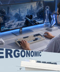 Game Ready Mechanical Keyboard Featuring Slick Tri Mode Wireless Bluetooth And 2.4GHz Setup For Lag Free Multi Device Pairing And A Rock Solid USB C Wired Backup For Gamers on a desk with a gaming monitor.