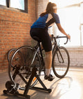 Cyclist using Magnetic Bike Trainer Stand For Indoor Cycling And Home Gym Use Foldable Stationary Bicycle Roller With Dual Lock System