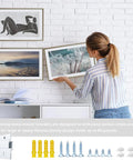 Woman hanging frames on a wall using Top Shelf Aluminum French Cleat Hanger Heavy Duty Wall Mount Kit For Mirrors Cabinets Shelves And Large Wall Art Two Pair Twelve Inch Span Eighty Pound Legit Strength Rock Solid Grip No Sweat Install For Basement Or Home Workspaces.