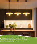 Vintage Edison Style LED Bulbs Dimmable ST58 E26 2700K Soft White hanging over kitchen table with amber glow