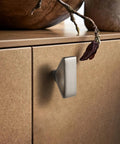 Side view of a cabinet with a Six Pack Brushed Nickel Triangular Cabinet Knob With Open Center Design installed, showing geometric flair.