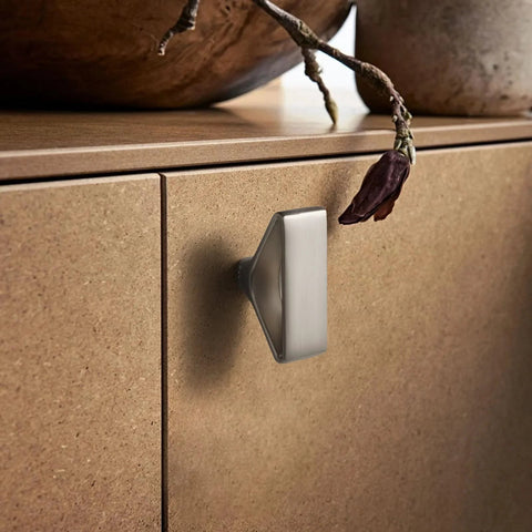 Side view of a cabinet with a Six Pack Brushed Nickel Triangular Cabinet Knob With Open Center Design installed, showing geometric flair.