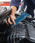 Person using 80cc Manual Grease Gun With Precision Locking Nozzle on car engine for smooth flow control and high capacity lubrication.