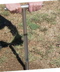 Person using Heavy Duty Stainless Steel Soil Sample Probe Core Sampler with T Handle on grassy lawn