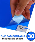 Heavy Duty Tear Away Sticky Adhesive Floor Mats 36 By 18 Inch Grit Eater Mud Scoop 300 Sheets Blue Disposable shoe soiler, detailing a sheet being peeled.