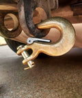 Close-up of 4 Pack 5/16 Inch Grade 70 Clevis Slip Hooks With Safety Latches used in towing setup on a vehicle hitch.