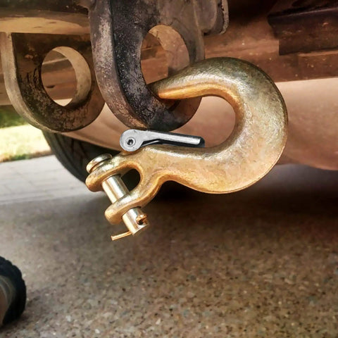 Close-up of 4 Pack 5/16 Inch Grade 70 Clevis Slip Hooks With Safety Latches used in towing setup on a vehicle hitch.