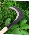 Long Handle Manganese Steel Hand Scythe for Weeding and Gardening with comfy grip shown cutting green plants