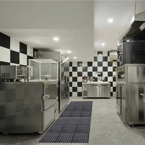 Anti Fatigue Rubber Floor Mat 36 x 36 Inch Interlocking Black Grippy Heavy Duty Anti Slip Kitchen Bar Floor Mat For Restaurant Wet Areas Bath Garage And Garden Use installed in a commercial kitchen.