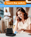 Woman using Fast Heating Electric Mug Warmer Featuring Four Adjustable Heat Settings And Smart Auto Shutoff to keep coffee hot.
