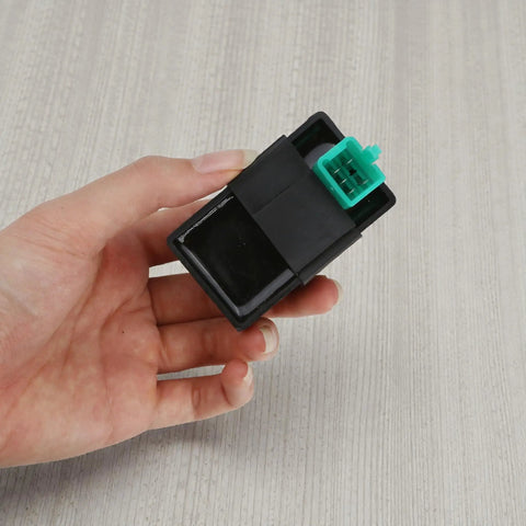 Person holding 5 Pin AC CDI Box For 50cc To 135cc Chinese ATVs Dirt Bikes Quads And Go Karts With Universal AC Fired CDI Unit 5 Pin Male Plug