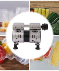 Heavy Duty Dual Cylinder Oil Free Vacuum Pump With Slick 110V Copper Motor 1440RPM in center with vacuum sealed food products.