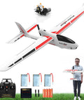 RC Glider Plane 4Ch With 6 Axis Gyro for Beginners, shown with remote, batteries and manual, large 23.6 by 18.1 inch white RC airplane.