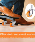 Swap Furniture Wobbles Fast With These One Inch Mini Swivel Casters Featuring Threaded Stems And Silently Rolling Nylon Wheels Built Tough For Tables And Workspace Chairs In Bright Matte Orange under a foot on a dark chair.