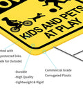Close-up of Slow Down Kids And Pets At Play Sign 2 Pack With Metal Stakes, showing durable corrugated plastic material